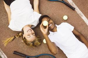 Two people laying on the ground photo